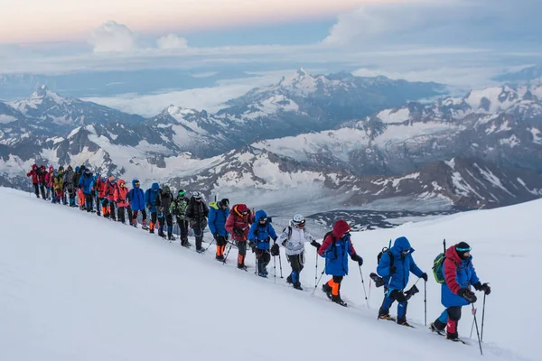 Caucasus / Russia - 07.23.2018 Group of climbers climbing mountain peaks.