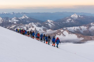 Caucasus / Russia - 09/09/2018 Group of climbers climbing mountain peaks