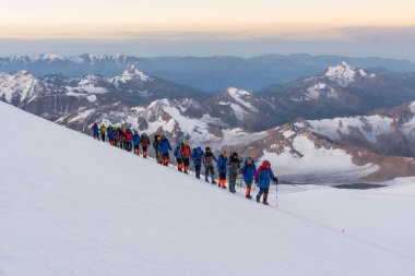 Caucasus / Russia - 09/09/2018 Group of climbers climbing mountain peaks