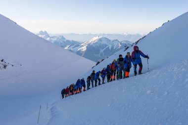 Caucasus / Russia - 09/09/2018 Group of climbers climbing mountain peaks