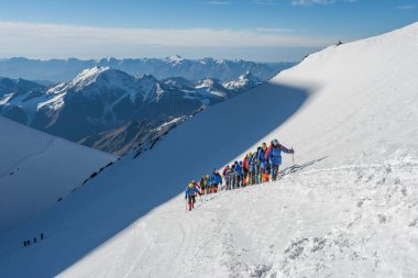 Caucasus / Russia - 09/09/2018 Group of climbers climbing mountain peaks