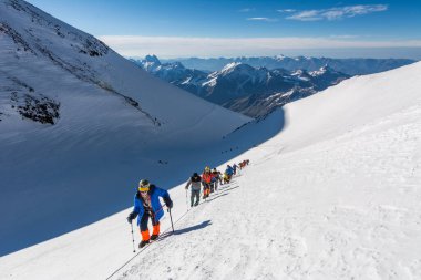 Caucasus / Russia - 09/09/2018 Group of climbers climbing mountain peaks