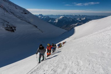 Caucasus / Russia - 09/09/2018 Group of climbers climbing mountain peaks