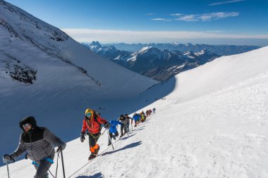 Caucasus / Russia - 09/09/2018 Group of climbers climbing mountain peaks