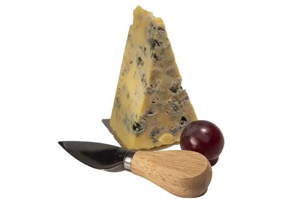 Mature Blue Stilton cheese with red grapes and knife  isolated on a white background