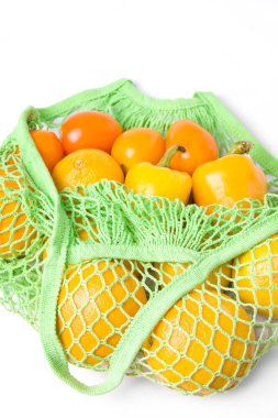 Beyaz arka planda biberli, portakallı ve domatesli yeşil iplik torbası. Ekolojik paket. Ekoloji Çevre Koruma.