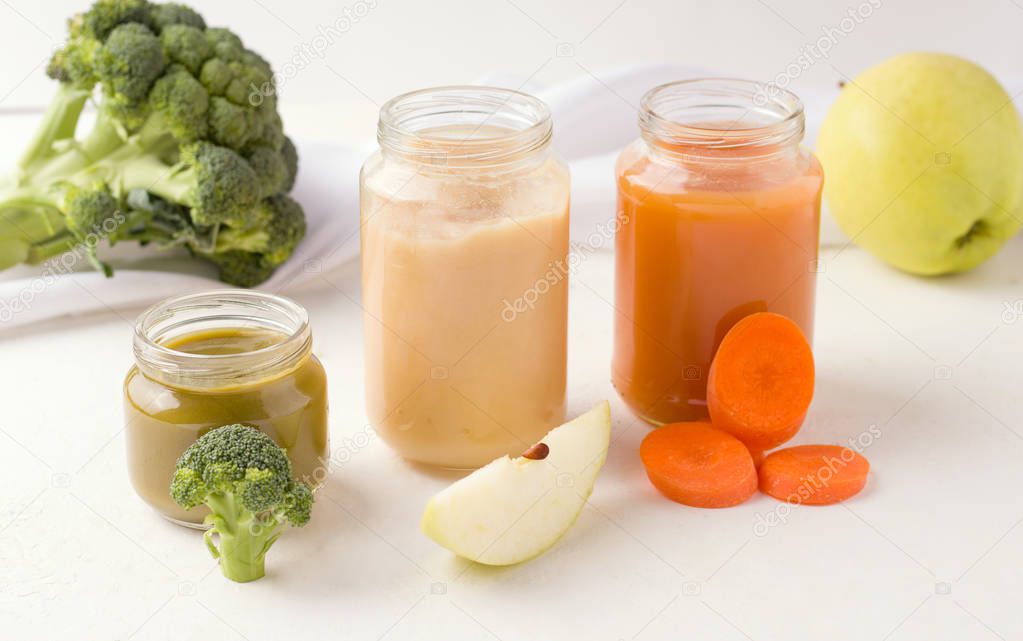 baby food homemade purees of different types such as broccoli, apple and carrots on a white background
