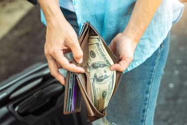 Sırt çantalı genç kadın gezgin ellerinde cüzdan dolar para planı tatil için bütçe tasarrufu ucuz indirim anlaşmaları Coronavirus 'un boş turizm krizinden sonra seyahat promosyon gezisi