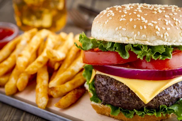 Hamburger on sesame seed bun with fries