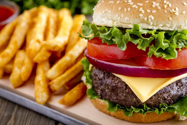 stock image Hamburger on sesame seed bun with fries