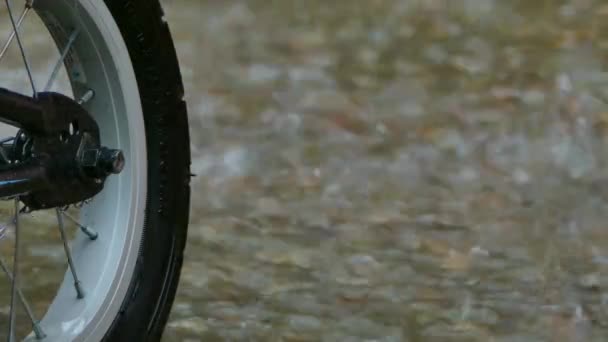 Βροχή στο φόντο των τροχό ενός ποδηλάτου — Αρχείο Βίντεο