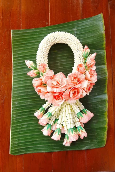 Made beautiful wedding garlands in hand on banana leaves and wood  nature