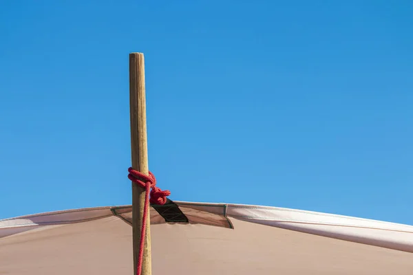 Stretch the canvas with wooden posts on the blue sky