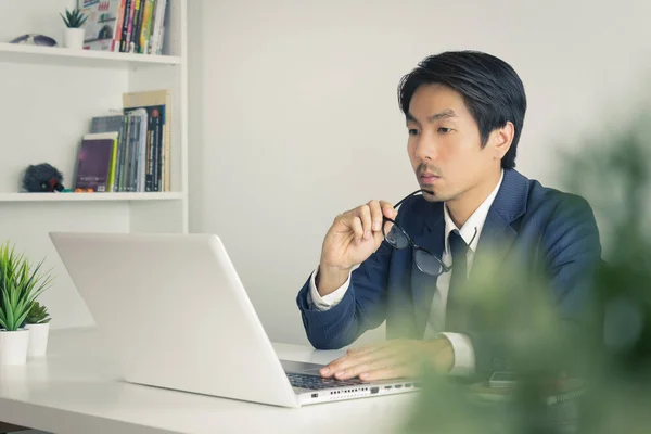 Asian Financial Advisor or Asian Consulting Businessman Serious with Financial Information in Vintage Tone