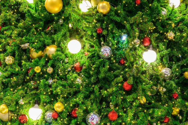 Işıklı ve renkli dekoratif malzemeli Noel ağacı süslemesi