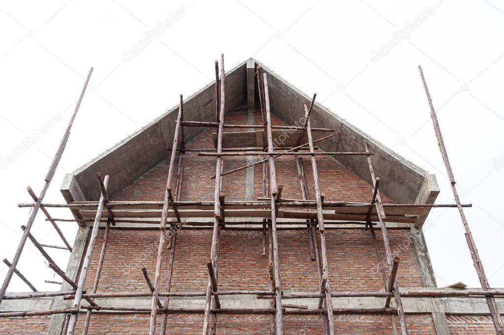 Under construction house with red brick wall and concrete structure