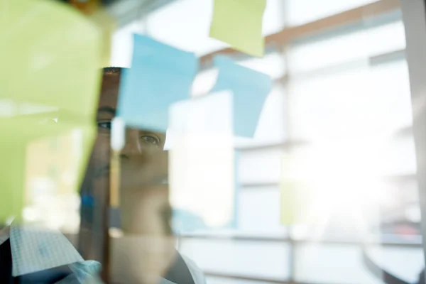 Dos propietarios de pequeñas empresas milenarias creativas que trabajan en una lluvia de ideas de estrategia de redes sociales utilizando notas adhesivas en ventanas —  Fotos de Stock