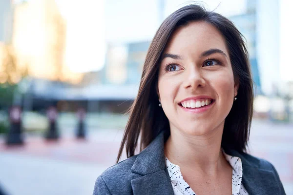 Millenial zakenvrouw lacht zelfverzekerd met stadsgezicht achtergrond — Stockfoto