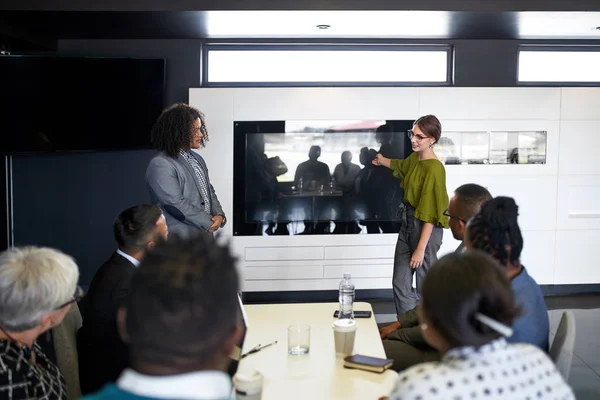 Multi-ethnic group of coworkers discussing in modern meeting roo Royalty Free Stock Images