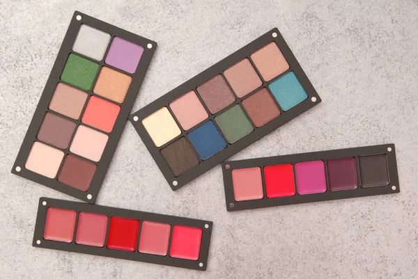 Palettes of lipstick, rouge, and eye shadow — Stock Photo, Image