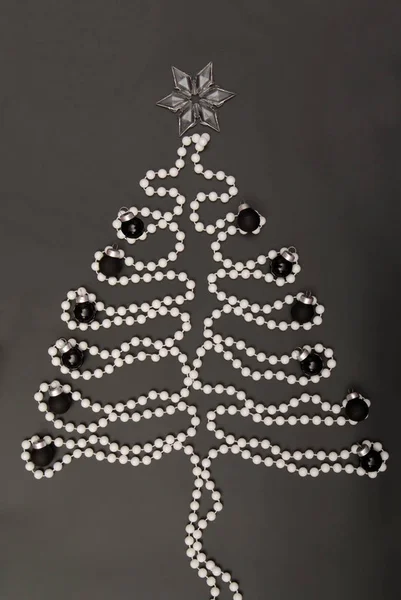 Symbolic  New Year's tree, New-year tree, white beads are on bla — Stock Photo, Image