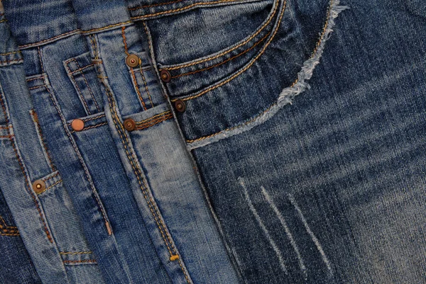 Horisontal denim background, assortment of blue jeans, pile of b — Stock Photo, Image