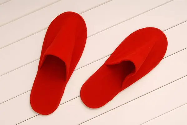 Red slippers from hotel, red slippers from airplane are on white — Stock Photo, Image