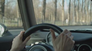 Sonbahar şehrinde direksiyondaki kadın eller. Şehir aracı ön cama doğru gidiyor.. 
