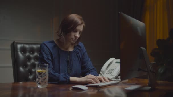 Young exhausted businesswoman working in night office. Sleepy female worker in front of monitor typing. — 비디오