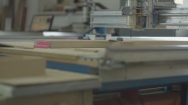 Milling process on computer numerical control machine in action in slow motion in different views. Carpentry workshop processes. Wooden furniture manufacturing. 