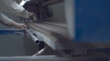 Carpenter working on wood polishing machine. Wooden furniture manufacturing process. Carpentry workshop. 