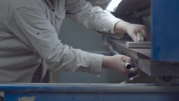 Carpenter working on wood polishing machine. Wooden furniture manufacturing process. Carpentry workshop. — Stockvideo