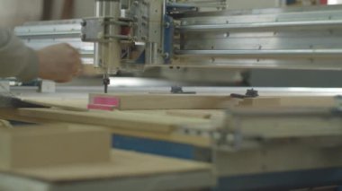 Milling process on computer numerical control machine in action in slow motion in different views. Carpentry workshop processes. Wooden furniture manufacturing. 