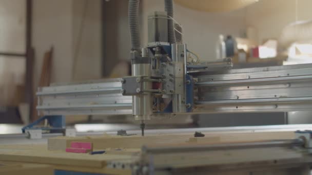 Milling process on computer numerical control machine in action in slow motion in different views. Carpentry workshop processes. Wooden furniture manufacturing. — Wideo stockowe