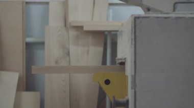 Timber in woodworking machine in action. Carpentry workshop processes. Wooden furniture manufacturing