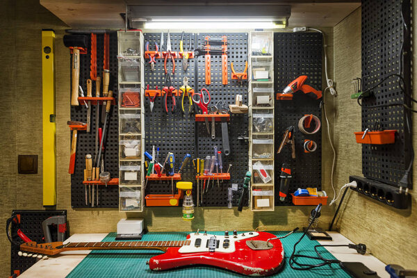 Luthier's Workbench With A Red Guitar