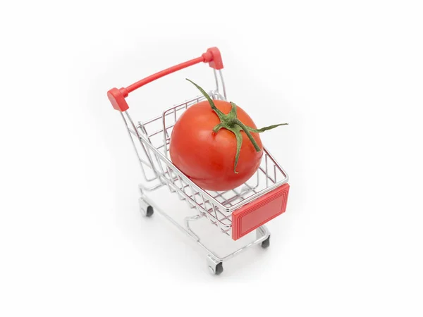 Tomate rojo cargado en un carrito de compras en miniatura — Foto de Stock