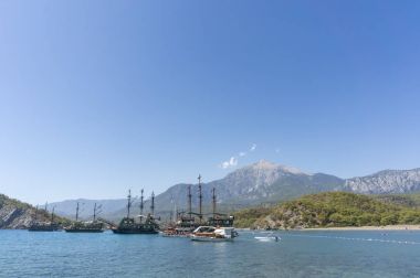 Touristic Galleons And Tour Boats Docked At Phaselis Beach, Antalya, Turkey clipart