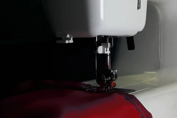 white sewing machine to sew a fabric