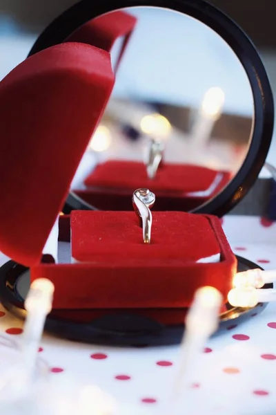 Jewelry composition in red box with reflections in mirror — Stock Photo, Image