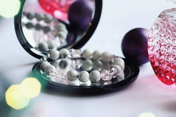 Jewelry composition with reflections in mirror with bokeh