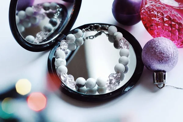 Jewelry composition with reflections in mirror with bokeh