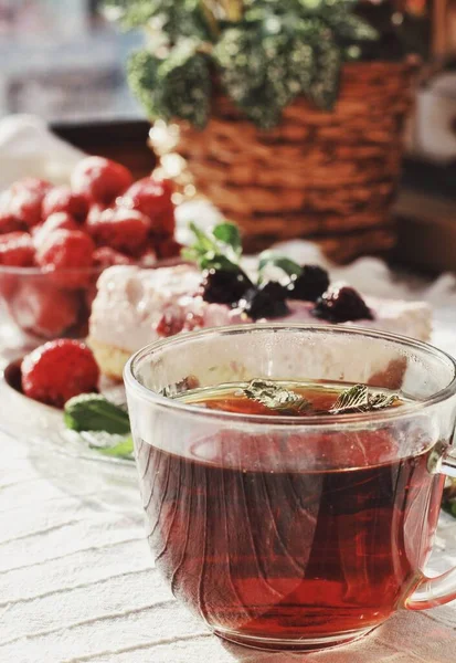Recipe of joy. Fresh delicious dessert with berries and green decoration, sweet food, tea time. Tasty cake and strawberries on white napkin in sunlight. Food and drinks, summertime, enjoyment.