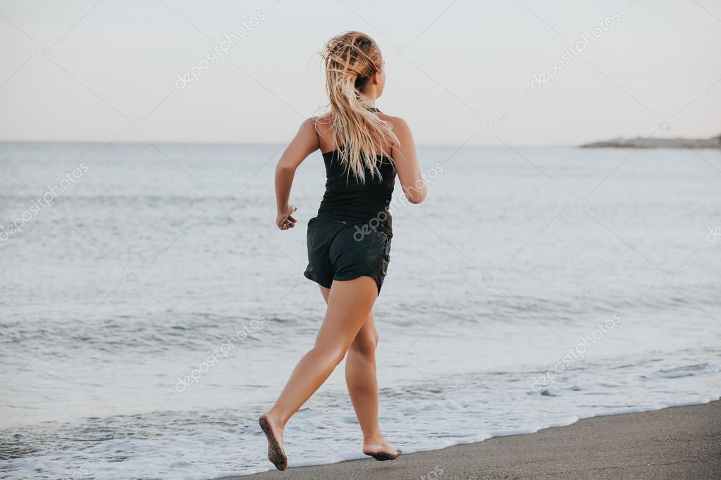 woman running barefoot