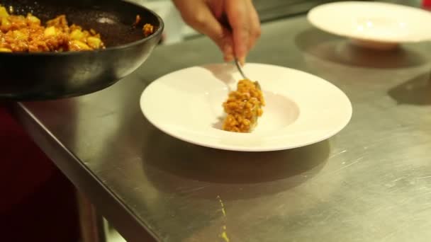 Close up of professional chefs serving a risotto dish in the kitchen. — Stock Video