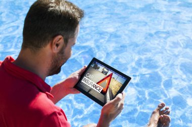 Adam araba sigortası bir tablet ile internet üzerinde araştırma.