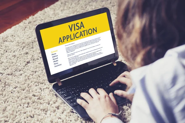 Wanita melakukan Visa Application elektronik dalam laptop melalui internet . — Stok Foto