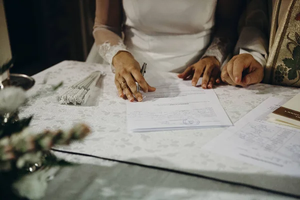 Bride signing wedding document after marriage ceremony — Stock Photo, Image