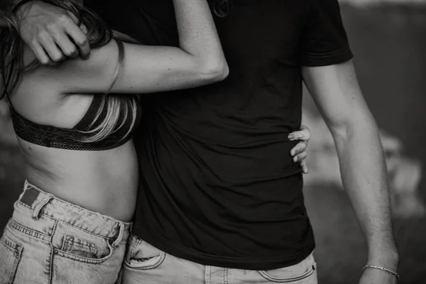 Primo piano di un paio di corpi che si abbracciano romanticamente. Bianco e nero . — Foto Stock