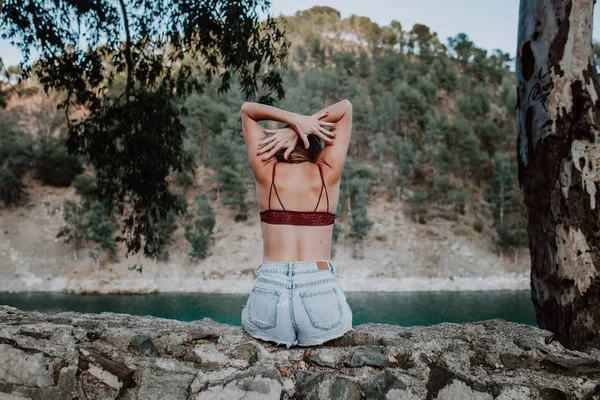 Vista trasera de la mujer en ropa interior a orillas del río — Foto de Stock